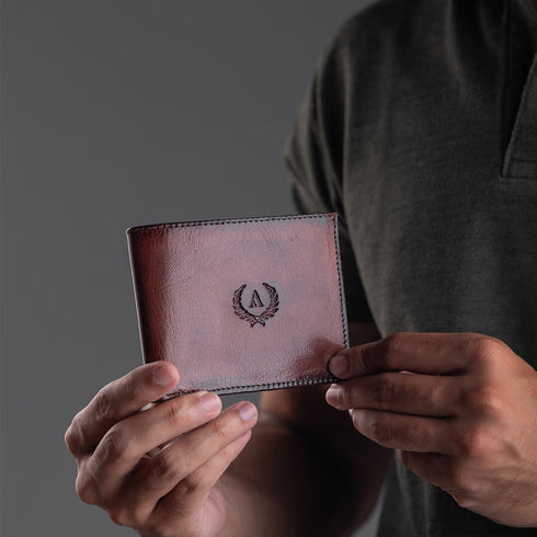 Blanc - A sleek, minimalist bi-fold wallet with an integrated flip ID section, Blanc is thoughtfully designed to maximise utility while maintaining an exceptionally slim profile. Model holding in his hands and showcasing the elegant finish of the wallet