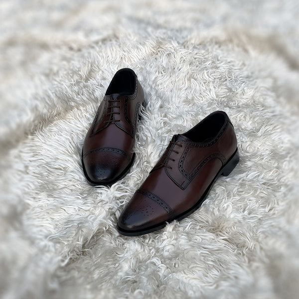 Edwin - A meticulously crafted Cap toe derby with an elegant toe medallion. The whole upper is embellished with carefully placed perforations and brogue-ing. 