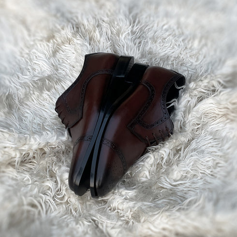 Edwin - A meticulously crafted Cap toe derby with an elegant toe medallion. The whole upper is embellished with carefully placed perforations and brogue-ing. 