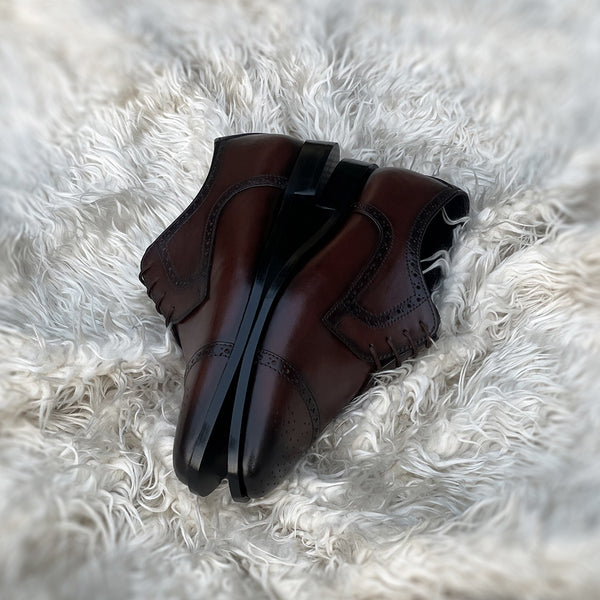 Edwin - A meticulously crafted Cap toe derby with an elegant toe medallion. The whole upper is embellished with carefully placed perforations and brogue-ing. 