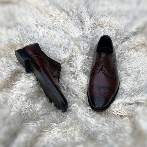 Edwin - A meticulously crafted Cap toe derby with an elegant toe medallion. The whole upper is embellished with carefully placed perforations and brogue-ing. 