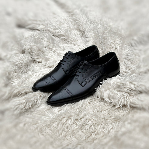 Edwin - A meticulously crafted Cap toe derby with an elegant toe medallion. The whole upper is embellished with carefully placed perforations and brogue-ing