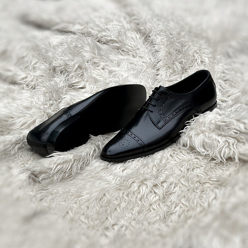 Edwin - A meticulously crafted Cap toe derby with an elegant toe medallion. The whole upper is embellished with carefully placed perforations and brogue-ing