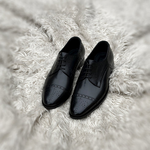 Edwin - A meticulously crafted Cap toe derby with an elegant toe medallion. The whole upper is embellished with carefully placed perforations and brogue-ing