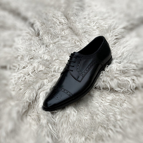 Edwin - A meticulously crafted Cap toe derby with an elegant toe medallion. The whole upper is embellished with carefully placed perforations and brogue-ing