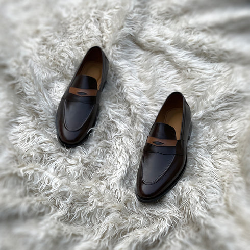 Millar 2.0 - Penny loafer made from the finest tannery dyed dark brown Calf leather along with contrasting yet complimentary leather tie detailing.