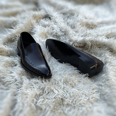 Simon - Whole-cut slip-on with hand-stitch detailing to create a pseudo apron. Meticulously hand-crafted using the finest Calf leather. Finished in the awe inspiring Carob patina.