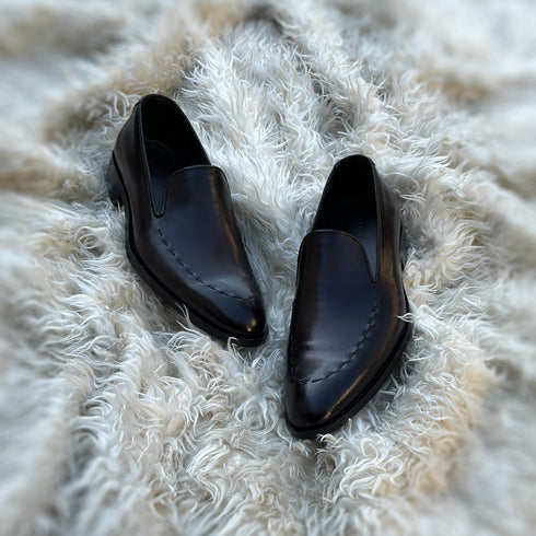 Simon - Whole-cut slip-on with hand-stitch detailing to create a pseudo apron. Meticulously hand-crafted using the finest Calf leather. Finished in the awe inspiring Carob patina.