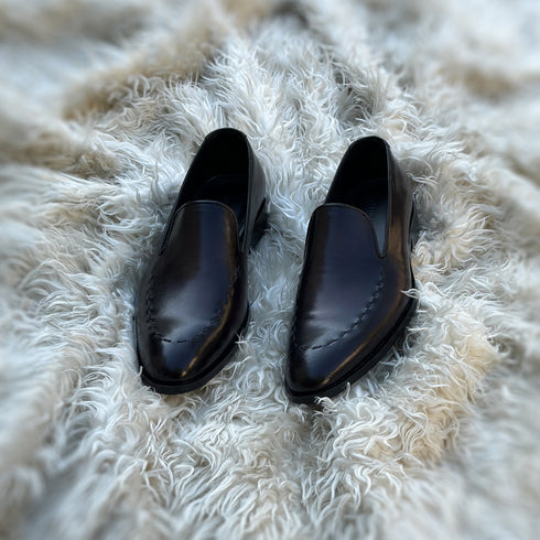 Simon - Whole-cut slip-on with hand-stitch detailing to create a pseudo apron. Meticulously hand-crafted using the finest Calf leather. Finished in the awe inspiring Carob patina.