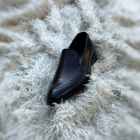 Simon - Whole-cut slip-on with hand-stitch detailing to create a pseudo apron. Meticulously hand-crafted using the finest Calf leather. Finished in the awe inspiring Carob patina.