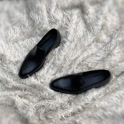 Simon - Wholecut slip-on with hand stitch detailing on the apron. Made from the finest black Calf leather, soft inner crust calf leather lining and welted vegetable tanned leather sole.