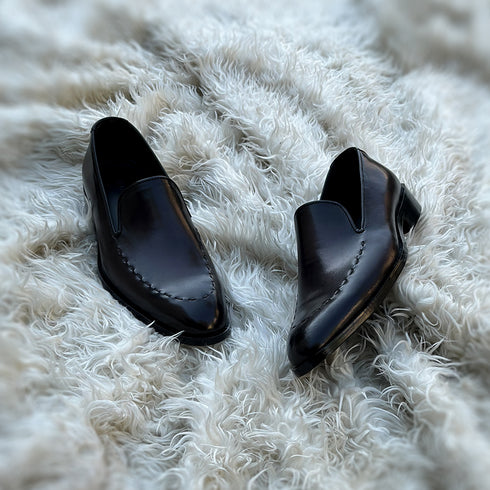 Simon - Whole-cut slip-on with hand-stitch detailing to create a pseudo apron. Meticulously hand-crafted using the finest Calf leather. Finished in the awe inspiring Carob patina.